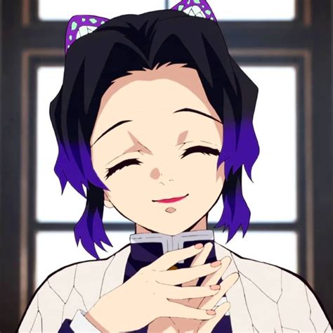 Kanao is a short, young girl with large, gentle eyes of a dark lilac color that are framed by thick eyelashes. . Shinobu smiling